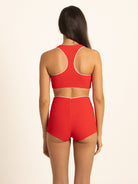 Back view of the Ruby red boy short swim bottoms, showing the complete full coverage design and smooth ribbed texture with white waist piping.