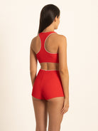Back 45-degree view of the Ruby red high waisted boy short bottoms by Ocean Mystery, showcasing the full coverage design and supportive ribbed fabric with contrast white piping.