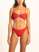 A high-quality image of the Ocean Mystery Ruby red ribbed bikini bottoms, featuring a flattering leg-elongating high-cut design and premium tactile fabric for a seamless, dig-free fit.