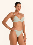 Sage green triangle bikini top style with delicate straps.