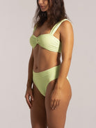 Side view of high-waisted lime green bikini bottom with flattering leg cut.