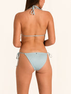 Back view of shimmer light blue tie side bikini bottom with cheeky thong cut.