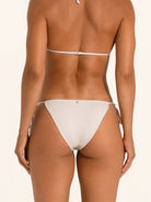 Back view of shimmer silver tie side bikini bottom with thong cut and tie straps.