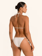 Back angle of shimmer silver triangle bikini top showing tie closure and metallic glow.