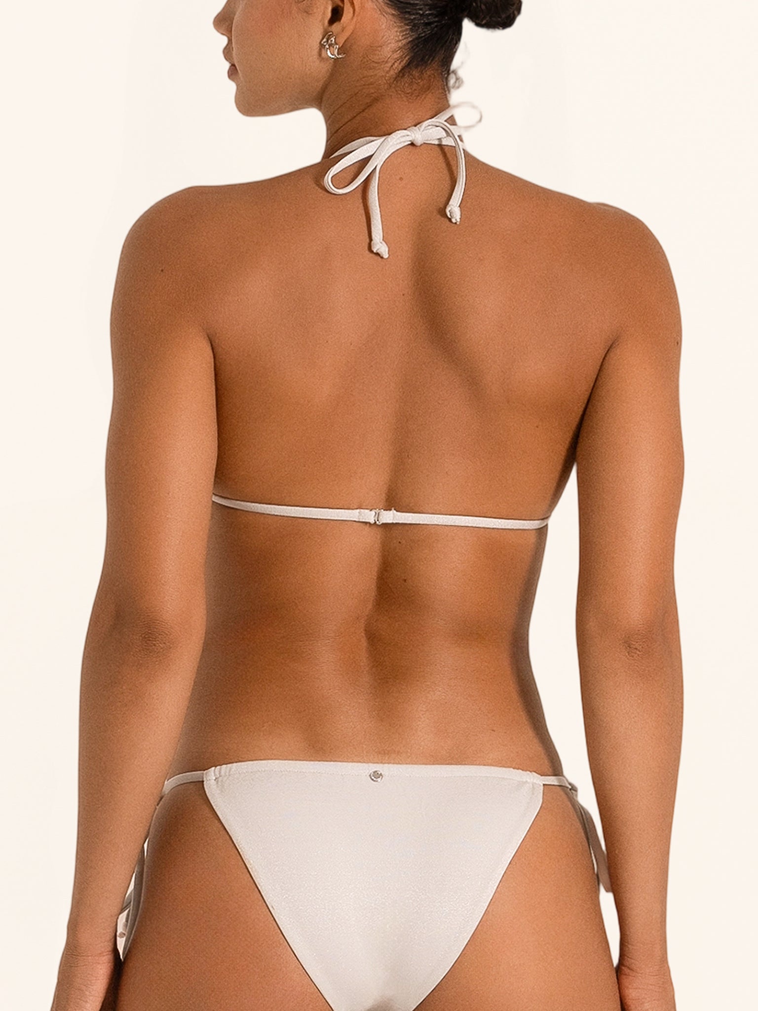 Back view of shimmer silver triangle bikini top with halter tie straps and open back.