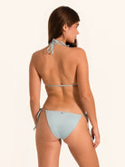 Back angle of shimmer light blue tie side bikini bottom showing cheeky coverage.