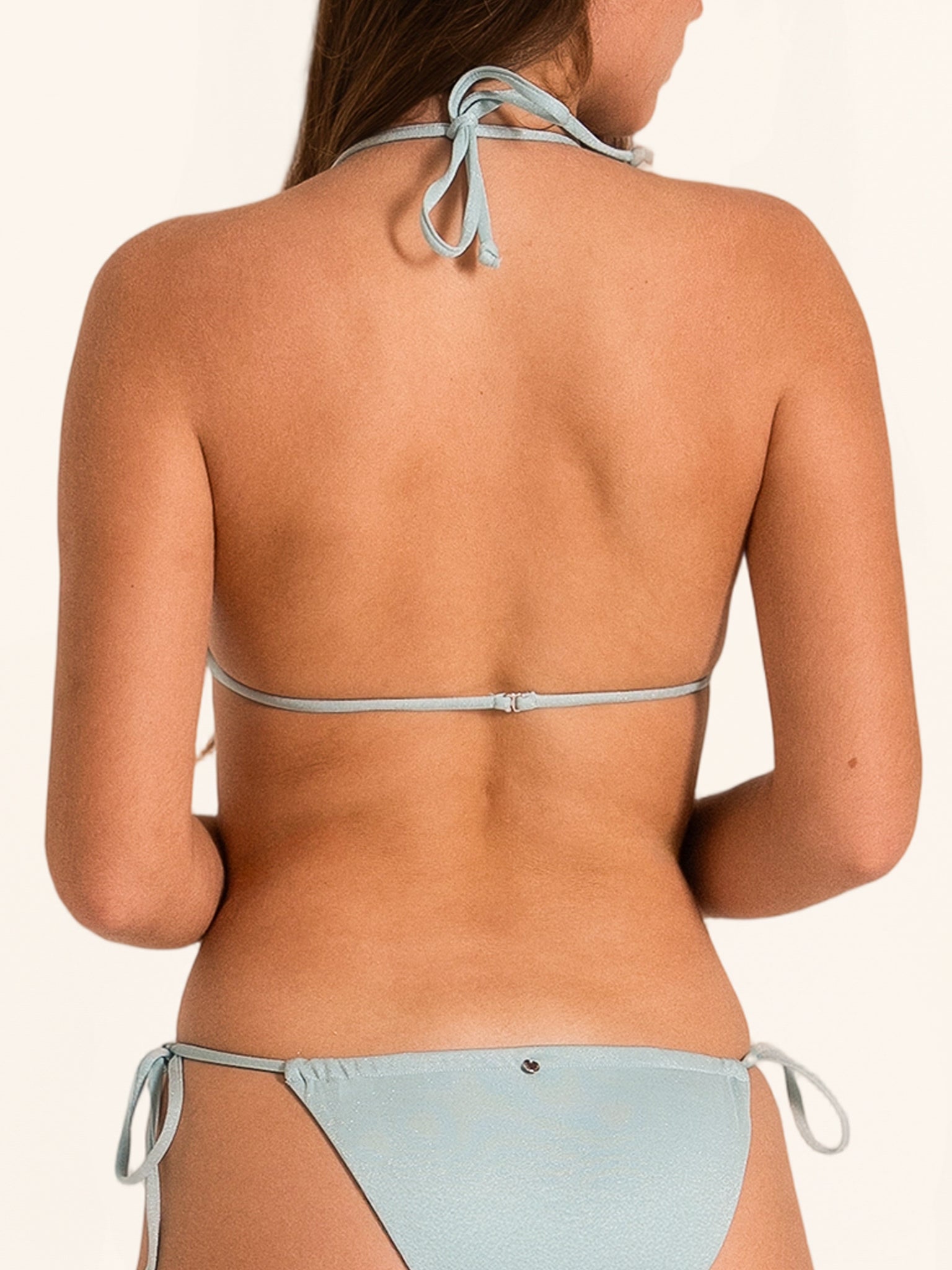 Back view of light blue shimmer bikini set with halter tie top and cheeky tie side bottom.