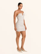 Full body front view of silver ruched mini dress strapless design