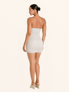Rear side angle of silver strapless mini dress with sweetheart neckline