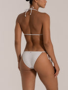 Side-rear angle of white shimmer bikini bottom with adjustable ties – Ocean Mystery Australia