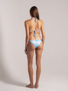 Back view of pastel blue tie-dye bikini set with halter neck and tie closure