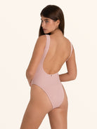 Soft pink one piece bathing suit with scoop neckline.