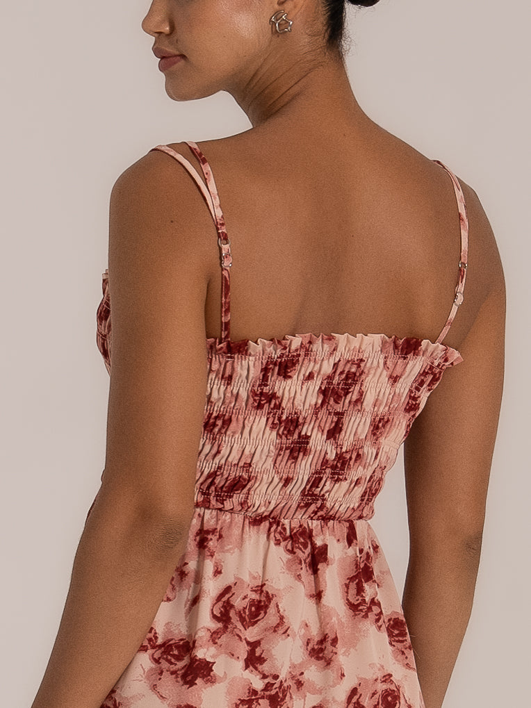 Back view of a white cutout dress with thin spaghetti straps and tie closure