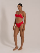 Front-facing model in red square-neck bikini set with sleek modern lines.