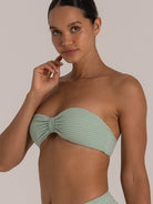 Close-up of mint green bandeau bikini top with ruched twist center