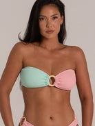 Front view of pastel pink and green bandeau bikini top featuring a central ring