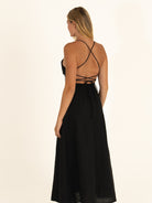Back view of the Onyx linen dress, featuring the stunning cross-back spaghetti straps and open back design.