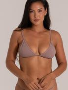 Front close-up of woman wearing textured taupe triangle bikini top