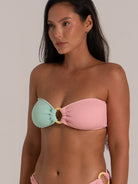 Close-up of textured bandeau bikini top with mint and pink panels and ring detail