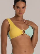 Close-up of a textured bikini top in mint and yellow with center ring and wide straps