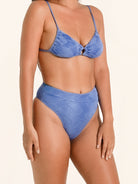 Women’s textured blue bikini bottom with modern high leg design.