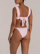 Back view of high leg bikini bottom in mint green with wide straps and soft textured fabric