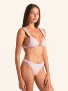 Women’s light pink bikini bottom with textured fabric and high leg shape.
