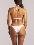 Rear shot of pastel pink bikini bottom with side bows and flattering cut