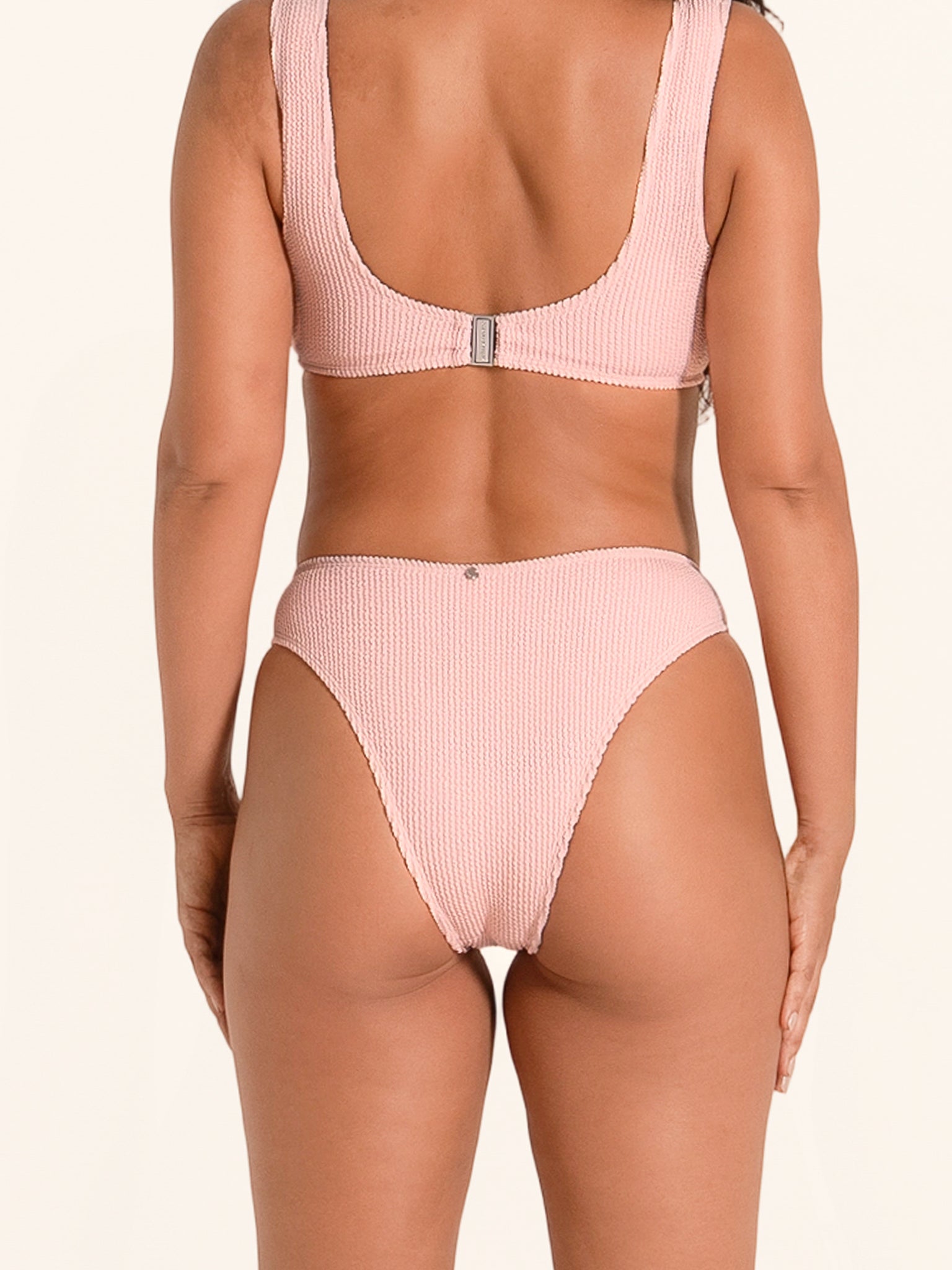 Textured pink swim bottom with flattering ring style design.