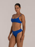 Side view of woman in royal blue square-neck bikini top