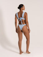 Back view of textured baby blue bikini with thick shoulder straps and large bow tie