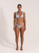 Front view of baby blue textured triangle bikini set on model