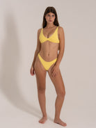 Front view of a mustard yellow textured bikini set with supportive top and high-leg bikini bottoms.