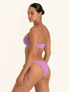 Back angle of purple tie side bikini bottom showing cheeky fit and tie straps.