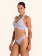 Trendy lilac bikini bottom with cheeky fit and cutout side style.