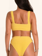 Trendy bikini top in mustard yellow with square neck and thick strap design.