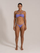Front view of twist front bandeau bikini set in purple with strappy detailing