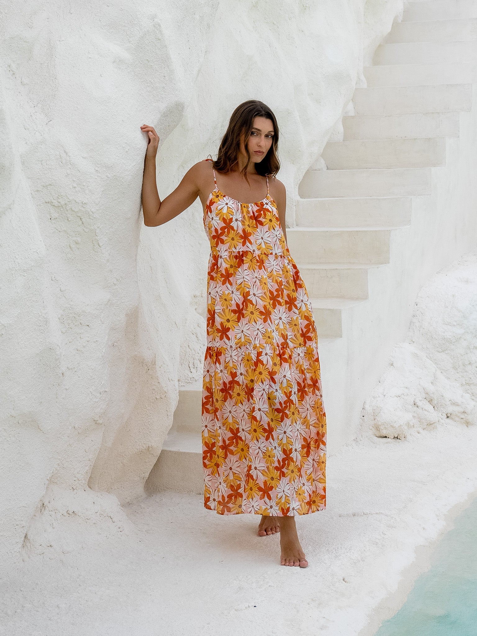 Vacation-style floral maxi dress on a woman by the water.