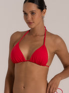 Side profile of vibrant red triangle bikini top with string ties