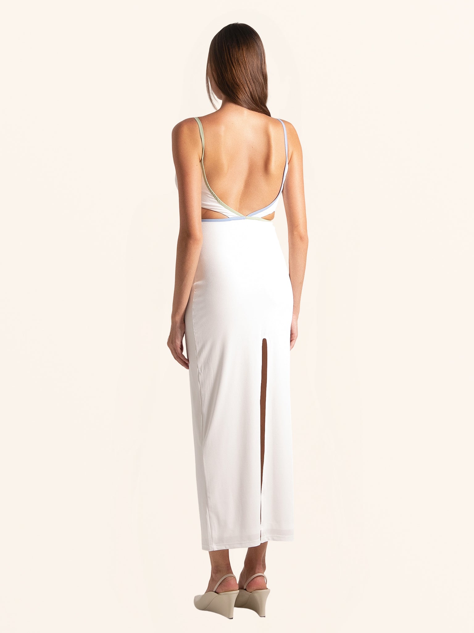 Rear view of white cut out maxi dress with back slit