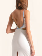 Model in white cut out maxi dress showing side slit design