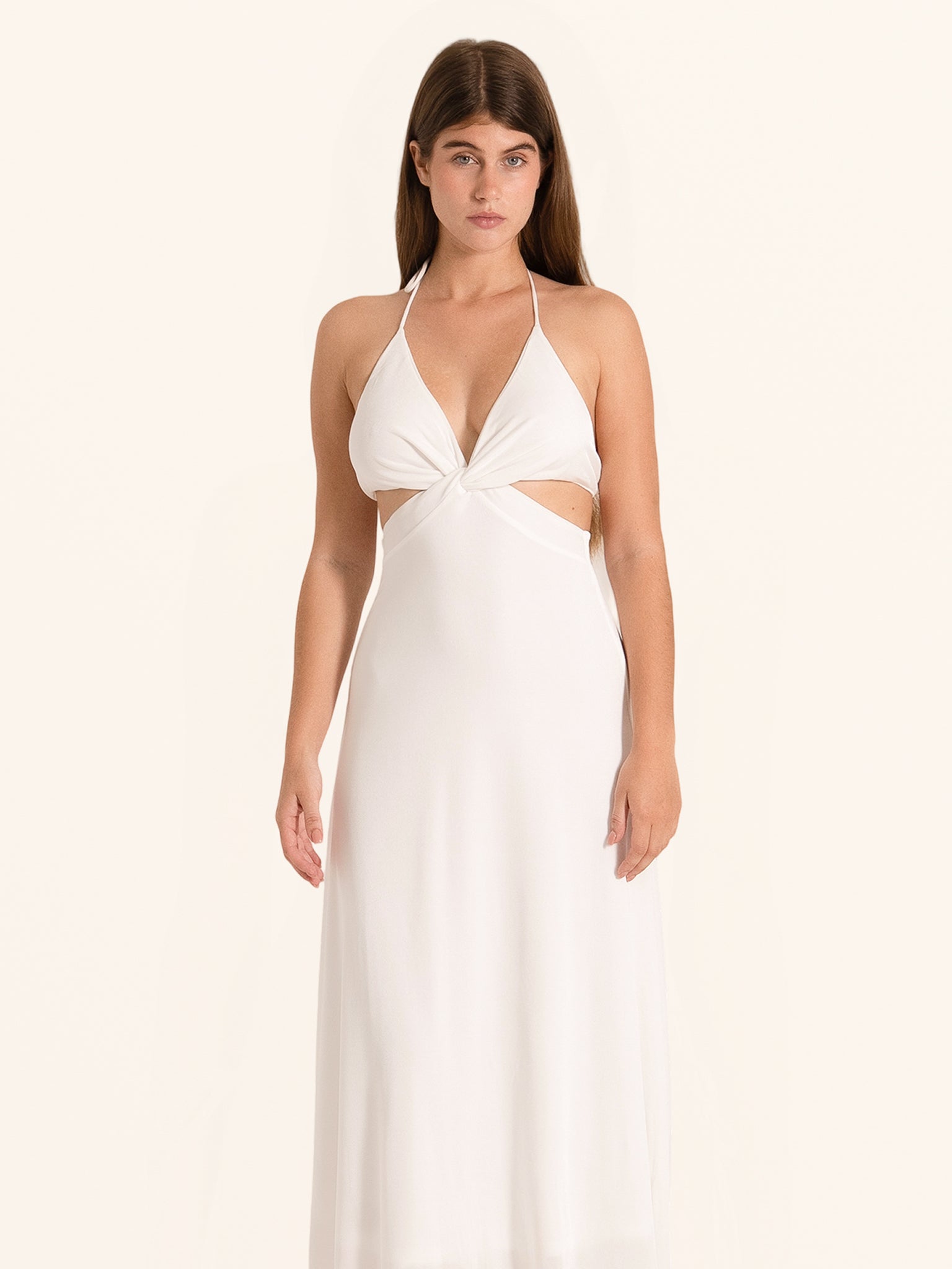 Front view of white halter cut out maxi dress with tie back design