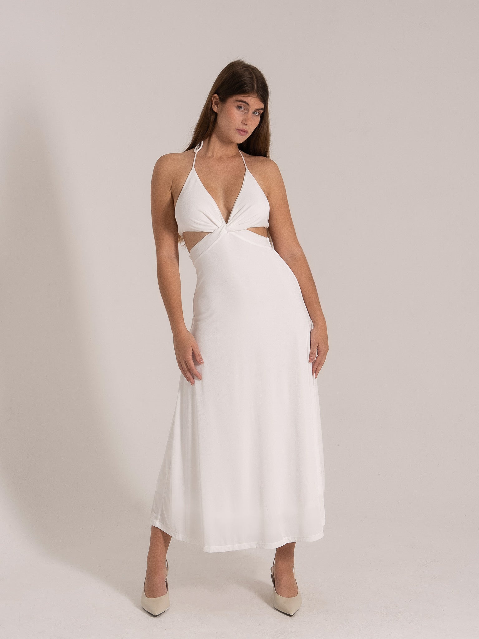 Elegant white beach dress with halter neckline and waist cut-outs