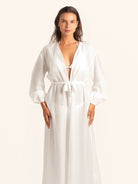 Front view of white long sleeve maxi cover up dress with belted waist