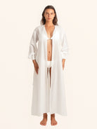 Front open style of white long sleeve maxi dress worn as beach cover up