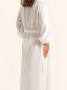 Back view of white maxi cover up dress with loose fit and tie belt