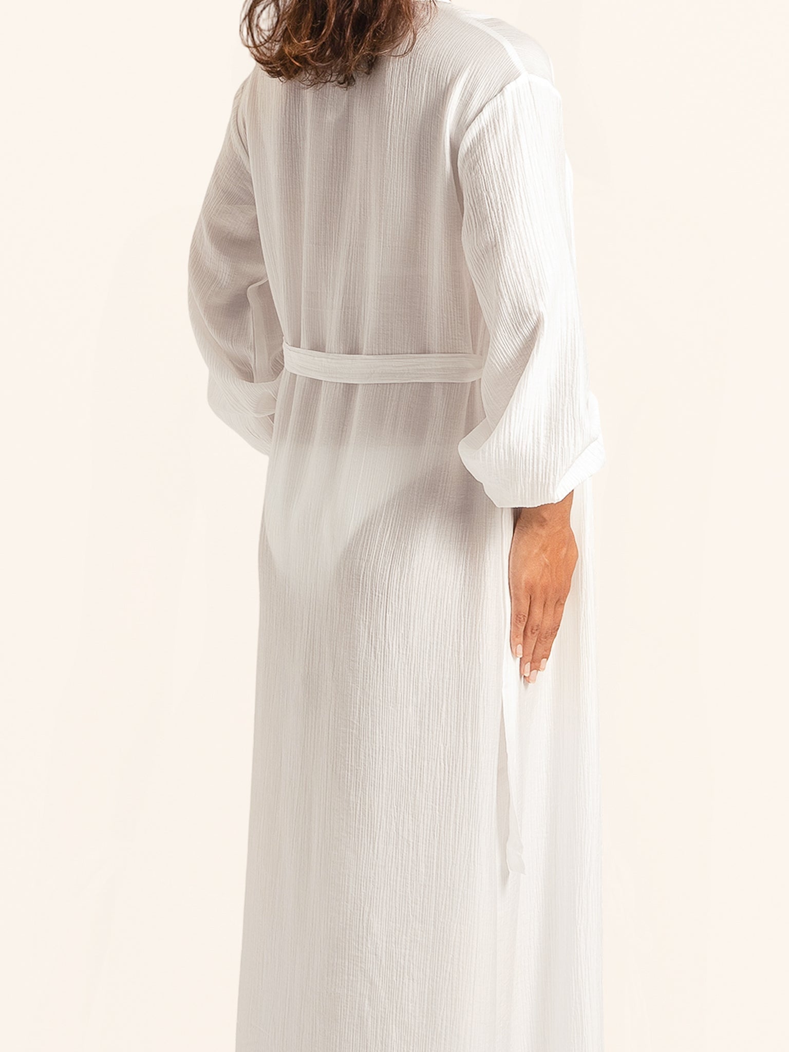 Back view of white maxi cover up dress with loose fit and tie belt