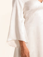 Closeup of white maxi dress with wide long sleeve design