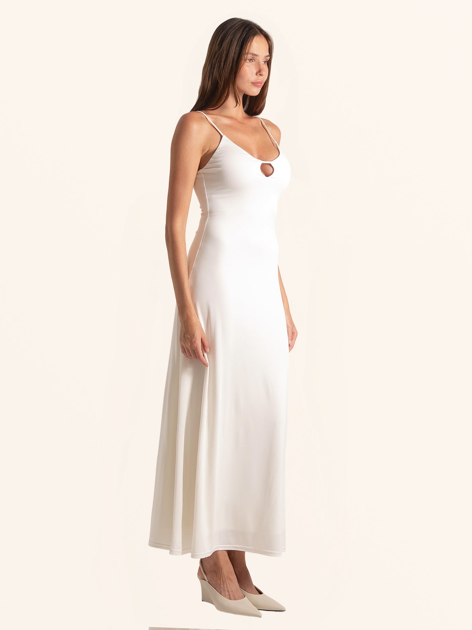 Side angle look of white midi dress featuring keyhole detail