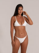 Front view of white triangle bikini set featuring delicate straps and subtle texture
